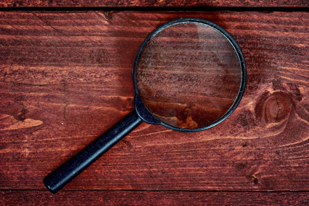Magnifying glass on wooden tableの写真素材