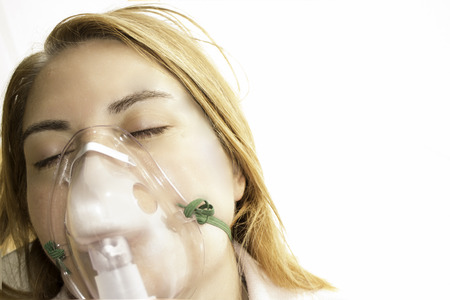 Woman with oxygen maskの写真素材