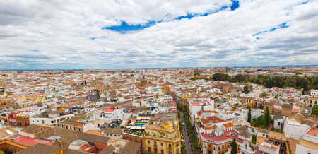 Beautiful panoramic view from the Giralda on the city of Sevilla, Andalusia, Spain. A lot of colored old  spanish houses and blue sky with white cloudsの写真素材