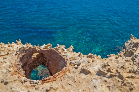 Beautiful sea lagoon view from the cliff near Grotto della Poesia, Salento, Italy in sunny summer dayの写真素材