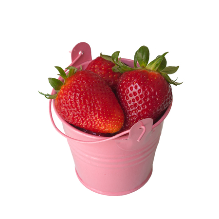Beautiful ripe red fresh strawberries with green leaves in purple colored pail on white background, close-upの写真素材