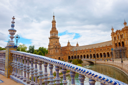 Seville, Spain, June 06, 2018: white and blue pattern on ceramic decorative railing of the bridge in Plaza of Spain, landmark in Seville The Plaza of Spain with view of castle on cloudy day, Andalusiaのeditorial素材