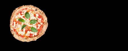 real italian pizza margherita with mozzarella cheese, tomato sauce, basilico in a black background from the top whit copy spaceの写真素材