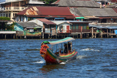 Boat traveling on a river in Thailand