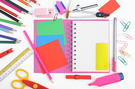 Open notebook and school or office tools on white backgroundの写真素材