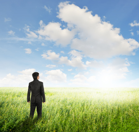 Vision business man in fields and sun sky for work sucsessの写真素材