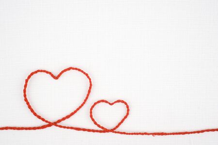 Heart shape rope on white fabricの写真素材