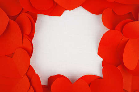 Red heart paper on white fabric for backgroundの写真素材