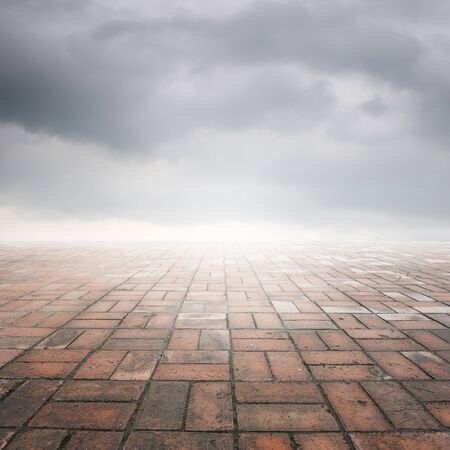 Brick floor and rainclouds for backgroundの写真素材