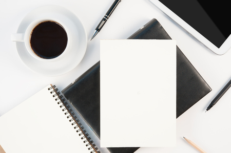Cup of hot coffee tablet phone and diary notebook on white background for text and background.Copy spaceの写真素材
