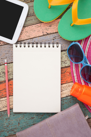 Straw hat, tablet and sunglasses on vintage wood.の写真素材