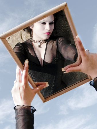 Gothic young woman posing outdoors at the seacoast of Valparaisoの写真素材