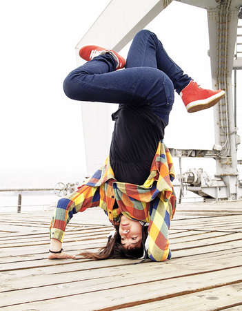 Young female breakdancing in a handstand poseの写真素材