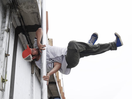 Breakdancer staying on a streetlamp