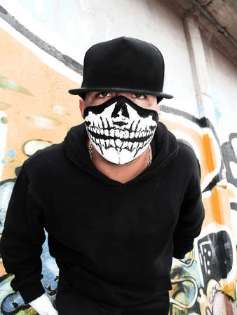 Street portrait of a rapper with a mask     の写真素材