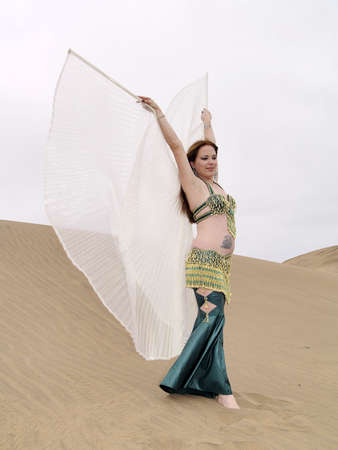 Pose of arab dance on the sand with wingsの写真素材
