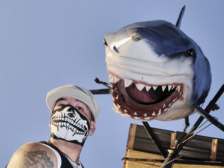 A rapper posing with a model shark