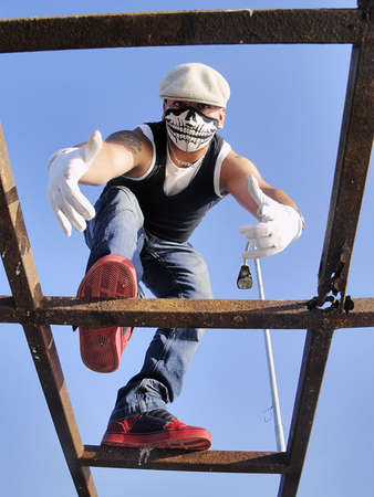 A rapper poses on a structure viewed from bottomの写真素材