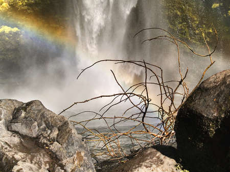 Waterfall and rainbow in a natural placeの写真素材