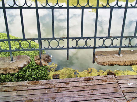 Detail of a rusted and worn-out railing in a bridgeの写真素材