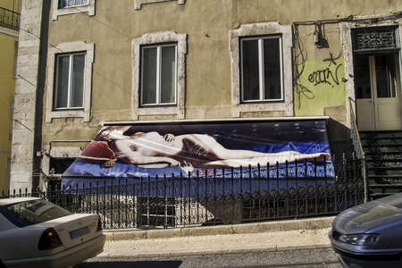 Nude woman painting on a commerce awning at Bairro Alto district in Lisbonのeditorial素材