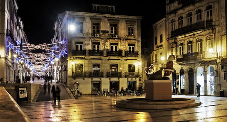 Coimbra, Portugal. December 2012. View of central May 8 Square at night, site of the townhall. Christmas setting on the street.のeditorial素材
