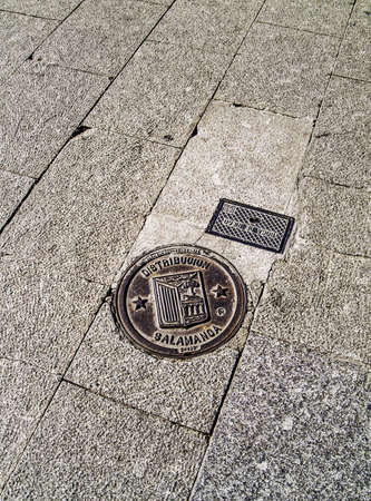 Salamanca, December 2012  Water supply lids with the coat-of-arms of Salamanca in the street pavement  の写真素材