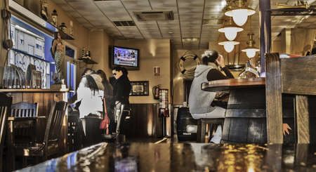 Mérida, November 2012. Interior view of a cafe. Seated people watching television. About 200,000 bars and cafes in Spain, only 1% drop from 2007 instead of economic crisis.のeditorial素材
