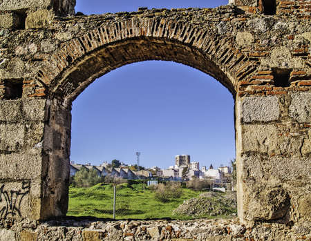 Merida, November 2012  Roman aqueduct ruins in Merida, capital of Extremadura region in Spain  I century  UNESCO World Heritage Site  Detail, MÃ©rida viewed throgh an arch のeditorial素材