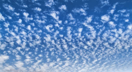 Clouds over a deep blue skyの写真素材