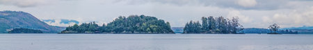 Panorama view of a lake with islands and mountains on winter