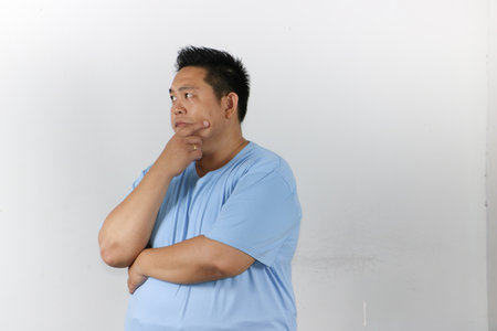 Man in hard Thought over isolated white backgroundの写真素材