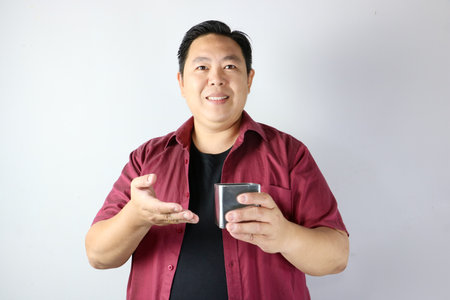 Smiling Happy Man presenting a stainless steel Gift Boxの写真素材