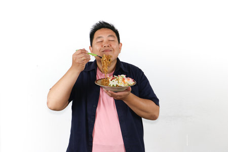 This Man's Happy Expression Smelling the Delicious Aroma of Fried Noodles with His Eyes Closedの写真素材