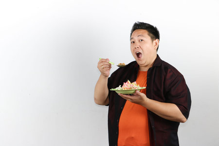 Man enjoying a delicious Indonesian Fried Rice with mouth open widely