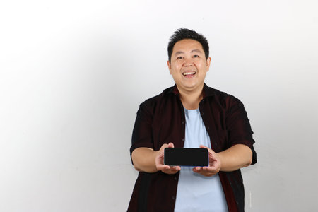 Man engrossed in mobile phone with a joyful expression