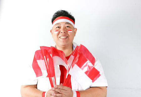 Asian male soccer fan posing in the studio, isolated on white.の写真素材