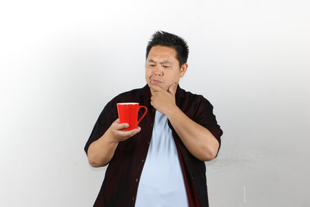 Young man with red mugの写真素材