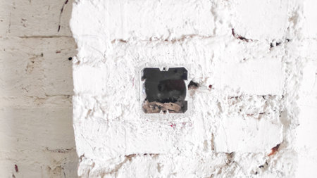 Broken white brick wall with hole in it. Background image.の写真素材