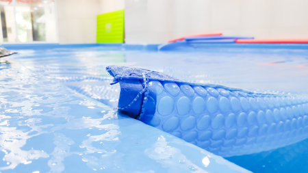 Swimming pool with blue and white swimming trunks and net.