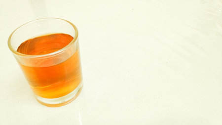 Glass of beverage on a white background, closeup of photo.の写真素材