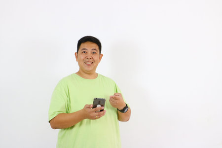 Man pointing at smartphone smiling full of happiness