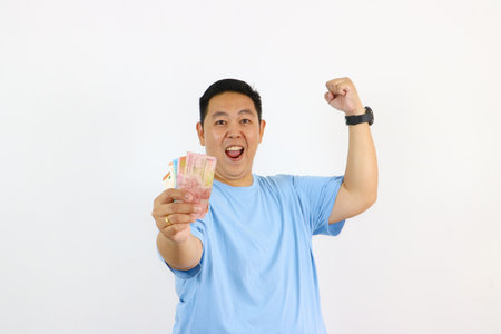 Portrait of asian Man holding money and pointing finger up