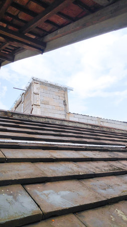 close-up photo of a roof tiled house made of clay, resistant to hot and cold weather