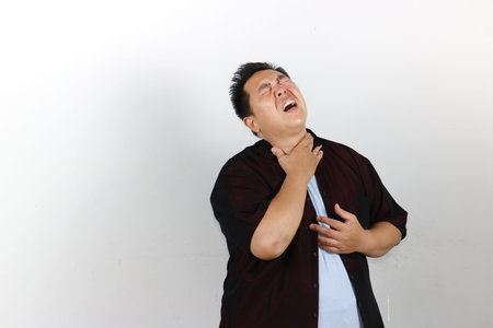 Indonesian Asian Man feeling bad emotional when suffering from sore throat because dehydration and...