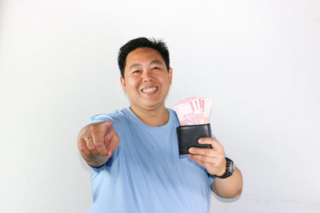 photo of asian man looks delighted while showcasing his wallet for finances freedom and cash savings...