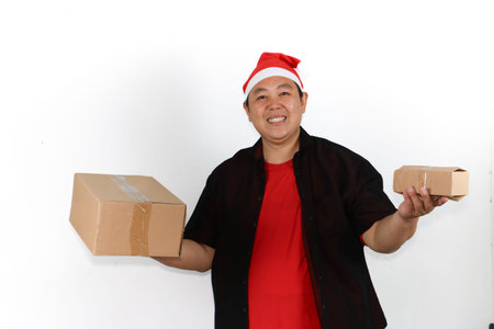Surprised Asian man wearing Santa hat showing smartphone screen for Christmas and New Year online...