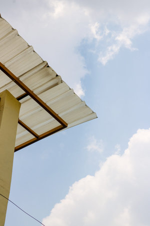 Translucent corrugated canopy roof against a clear blue sky