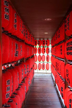 Rows of red Japanese paper lanterns with black kanji text means Business Open. Bandung 10 October...