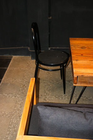 A stylish black iron cafe chair features a modern industrial design for outdoor diningの写真素材